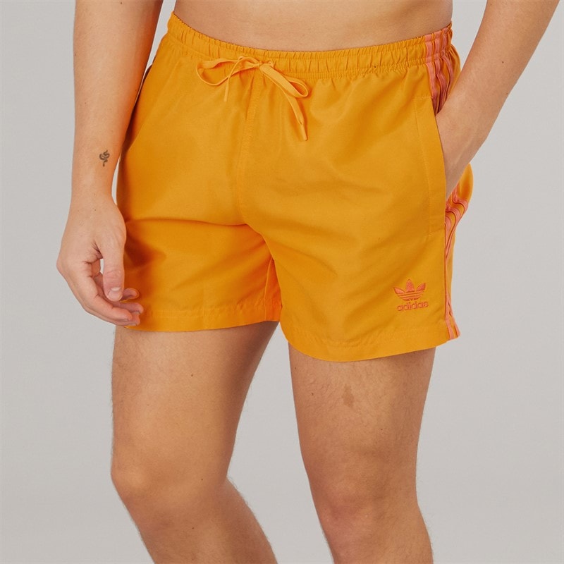 adidas Mens Adicolor 3-Stripes Five Inch Swim Shorts Real Gold - Image 1
